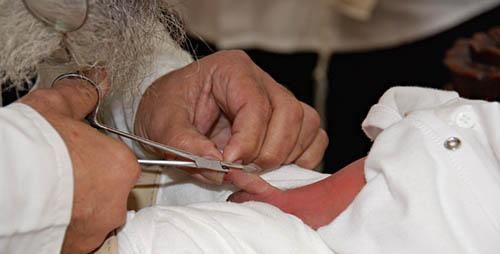 First the genitals of the newborn boy are cut…