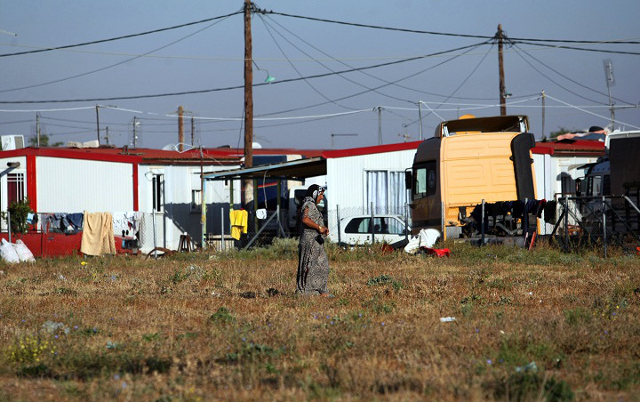 A Roma woman from Farsala looking in a field for children to steal.