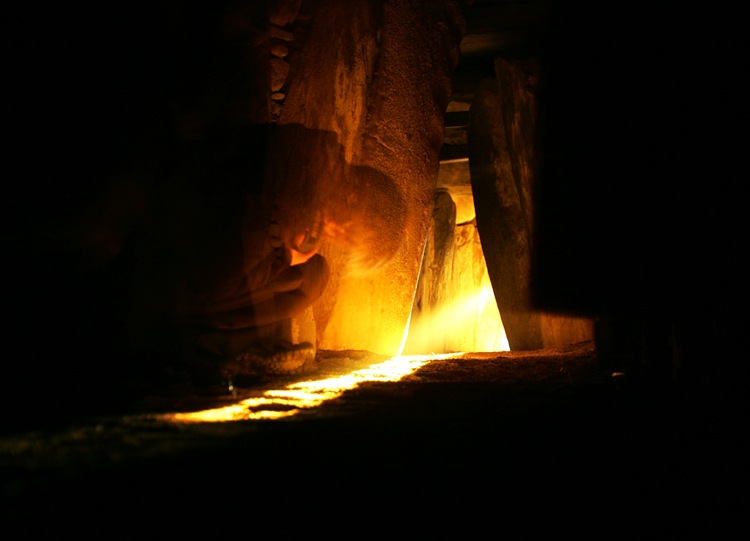 Photograph: Cyril Byrne The spirit of Newwgrange yesterday morning  while a woman bows her head  as the passage chamber is illuminated by the Wnter Solstice at the Co Meath site which was seen  on the web  for the first time.<br />Dec21st-07