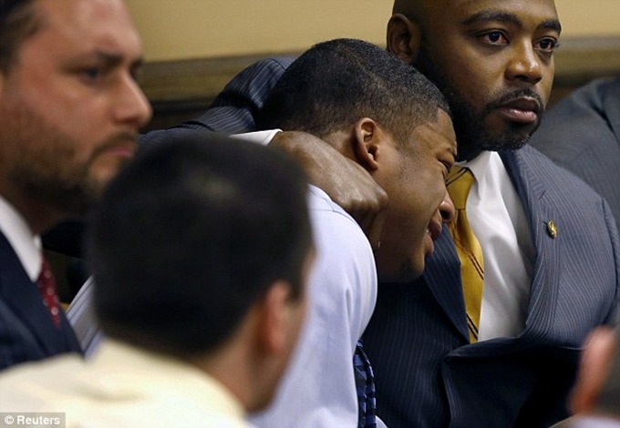 Defense attorney Walter Madison comforts Ma'Lik Richmond as he bawls his eyes out at being told he will have to pay for his crime. Defense attorney Walter Madison (right) comforts Ma'Lik Richmond (left) as Richmond reacts to the verdict during his trial at the juvenile court in Steubenville, Ohio on March 17, 2013