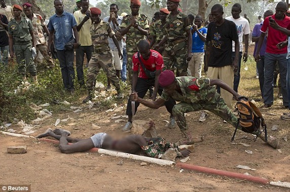 A Central African Army soldier stabs the man who was accused of joining the ousted Seleka rebel group A Central African Army soldier stabs the man who was accused of joining the ousted Seleka rebel group