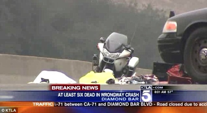 A family of four lies among the bodies with tarps over them on the busy highway A family of four lies among the bodies with tarps over them on the busy highway