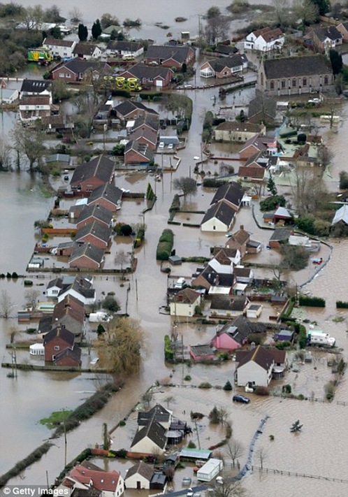 Water surrounds flooded properties in the village of Moorland on the Somerset Levels near Bridgwater Water surrounds flooded properties in the village of Moorland on the Somerset Levels near Bridgwater
