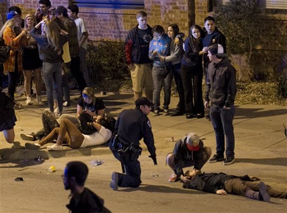 A bystander and a police officer tend to a man who was struck by a vehicle on Red River Street in downtown Austin, Texas, at SXSW on Wednesday March 12, 2014 A bystander and a police officer tend to a man who was struck by a vehicle on Red River Street in downtown Austin, Texas, at SXSW on Wednesday March 12, 2014