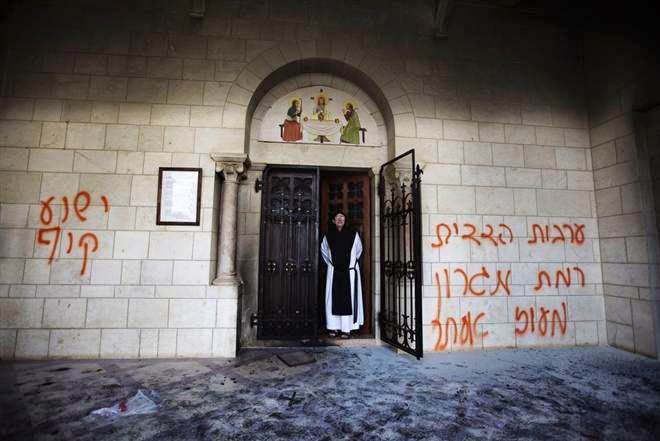 “Jesus is a monkey” once again spray painted on the wall. The door to the monastery was set ablaze.