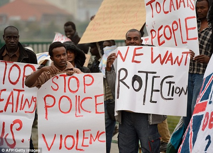 1409940943489_wps_2_Migrants_hold_placards_as 1409940943489_wps_2_Migrants_hold_placards_as