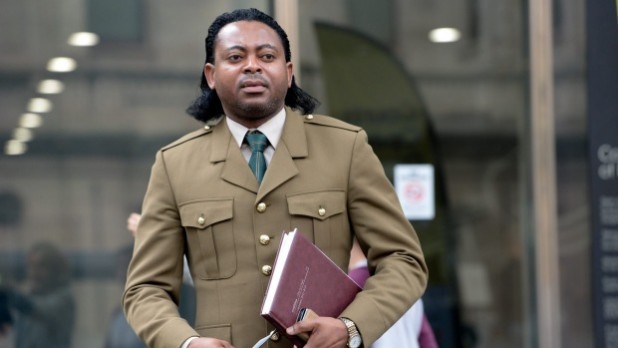 Holding a book makes him appear smart like White man.