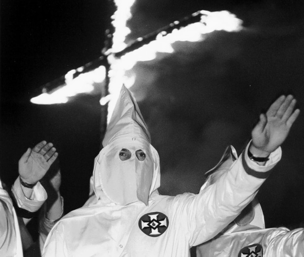 Members of the Ku Klux Klan salute at a gathering for the third Annual Hico KKK Rally in Hico, Texas, on Saturday, June 27, 1992. (AP Photo/Pat Sullivan)