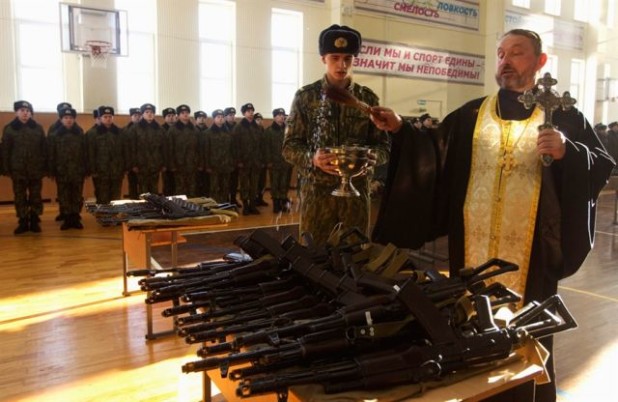 Russian priest blessing army weapons