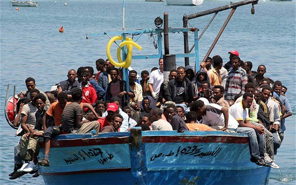 Would-be immigrants arrive on a boat in...Would-be immigrants arrive on a boat in the port of Italy's southern island of Lampedusa late on July 31, 2008. Italy's coast guard intercepted around 800 illegal immigrants on five boats off the island of Lampedusa on July 31. One boat, carrying 339 people, including 47 women and four children, got as far as the Sicilian island's port. The reception centre on Lampedusa, which can hold 700 immigrants, was overwhelmed by the scale of new arrivals after some 400 illegal immigrants turned up on the island. AFP PHOTO / Mauro Seminara (Photo credit should read Mauro Seminara/AFP/Getty Images)